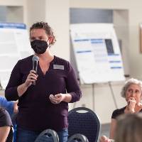 Mentor wearing mask asking question of presenter.